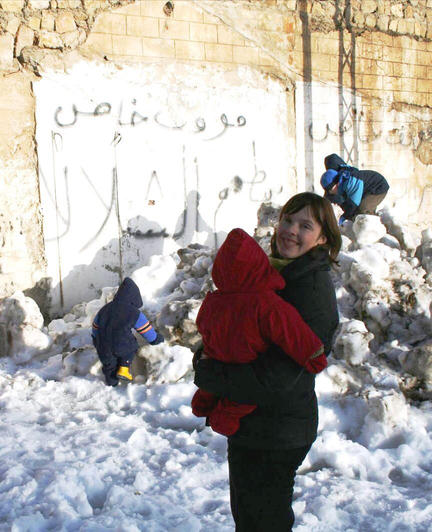 Emily and her three children outside after a rare snowstorm in Damascus, Syria.