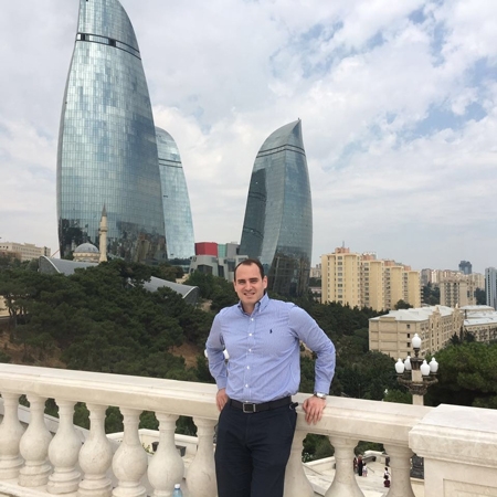 Obada standing in front of the Flame Towers in Baku, Azerbaijan.