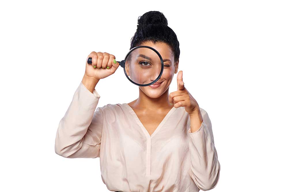 Business woman with magnifying glass - international business partner