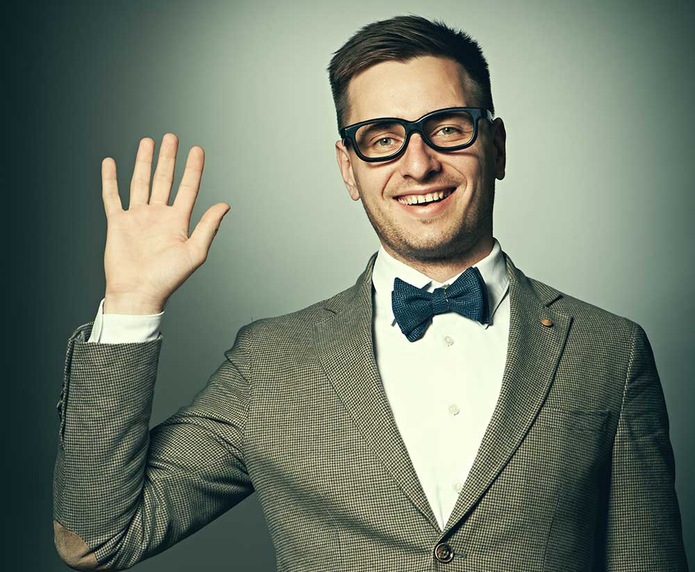 Businessman in bowtie and glasses waving hello
