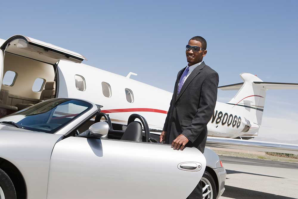 important business person getting into a car