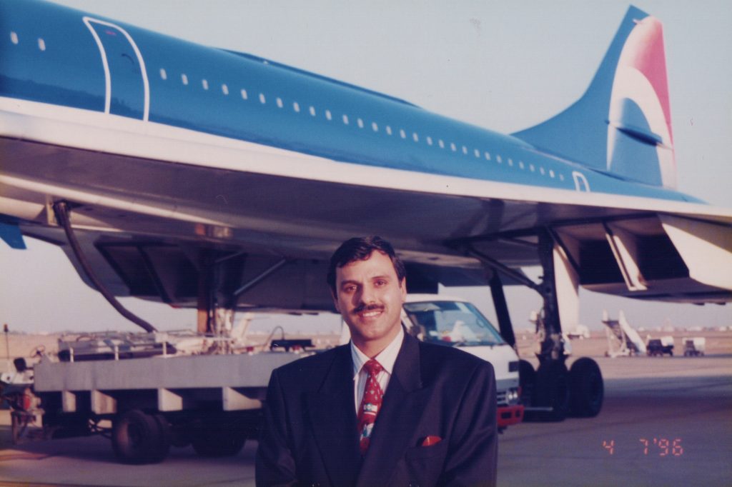 Tahir standing outside the Pepsi Concorde jet in Saudi Arabia, 1996.