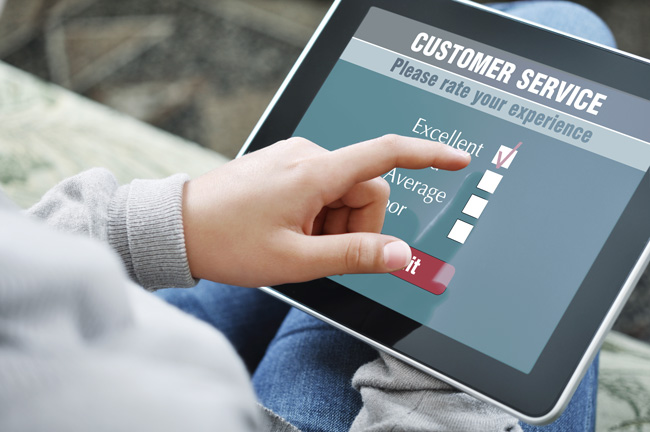 Person with tablet filling out customer satisfaction survey - servitization
