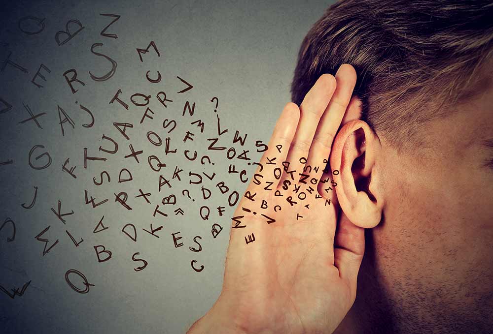 Man listening with letters flying into his ear