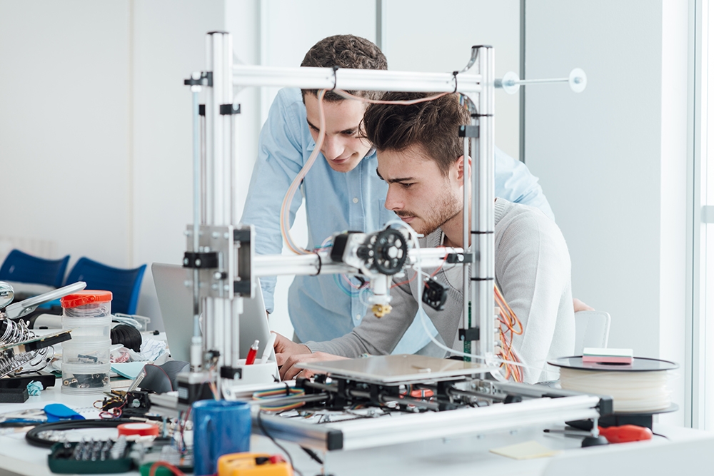 young entrepreneurs operating a 3D printer