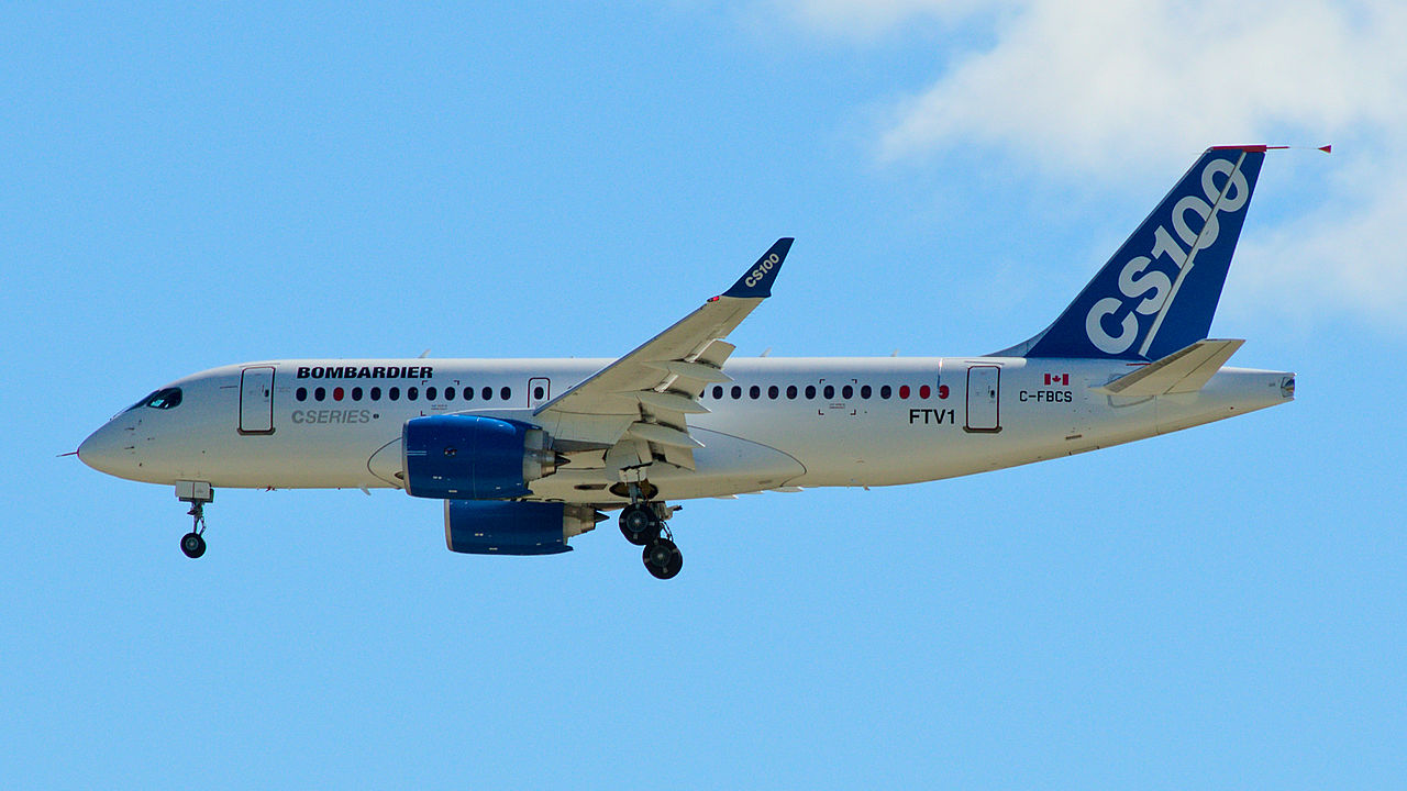 Bombardier CS100 flying in clear skies