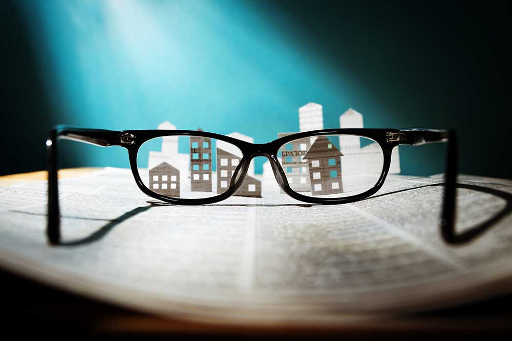 Pair of glasses magnifying papers