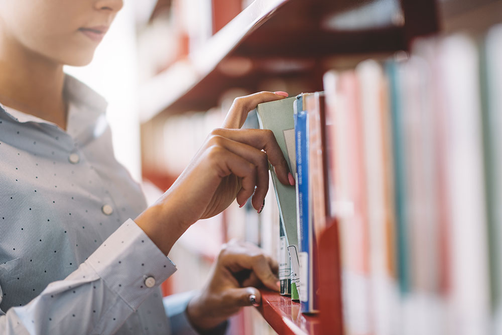 Woman selecting a book in a library