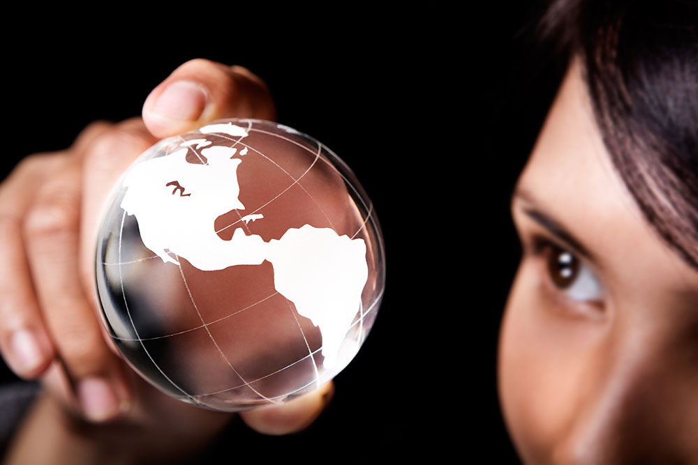woman looking at globe in her hand