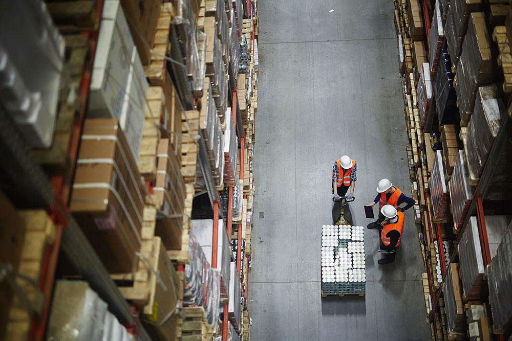 overhead view of 3 workers in a warehouse