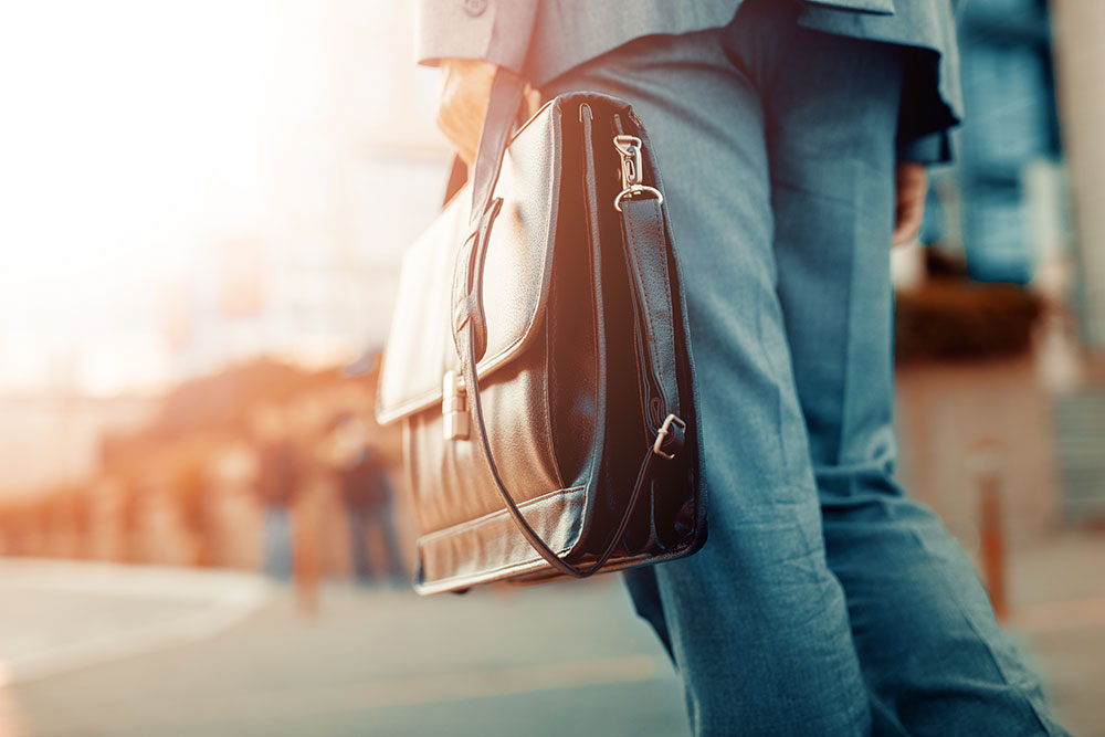 Close up of businessman holding a brief case