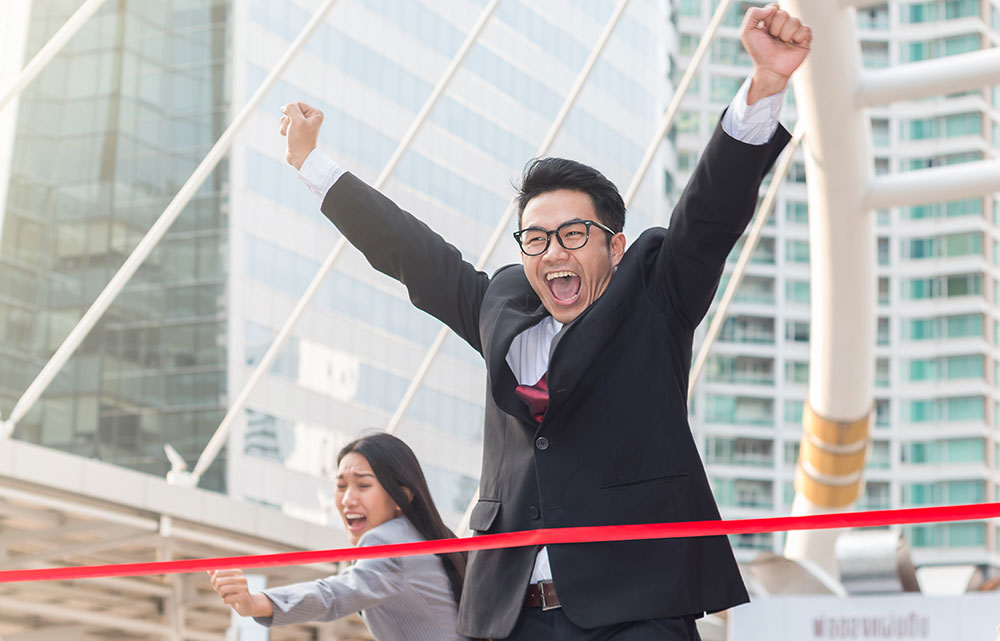 Business people crossing a finish line