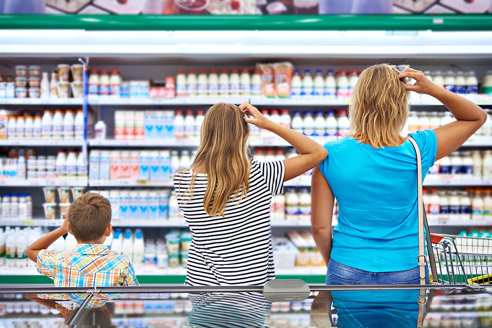 family confused looking at products in grocery store