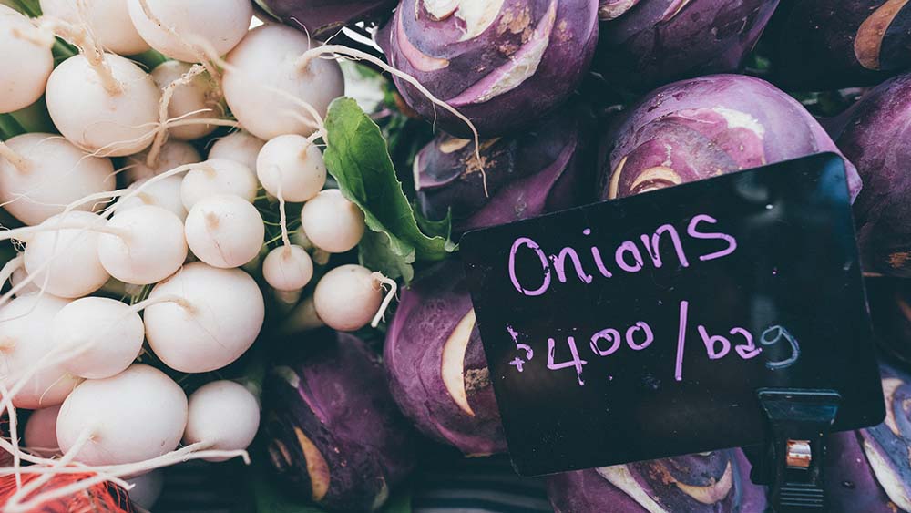 Onions for sale and price tag