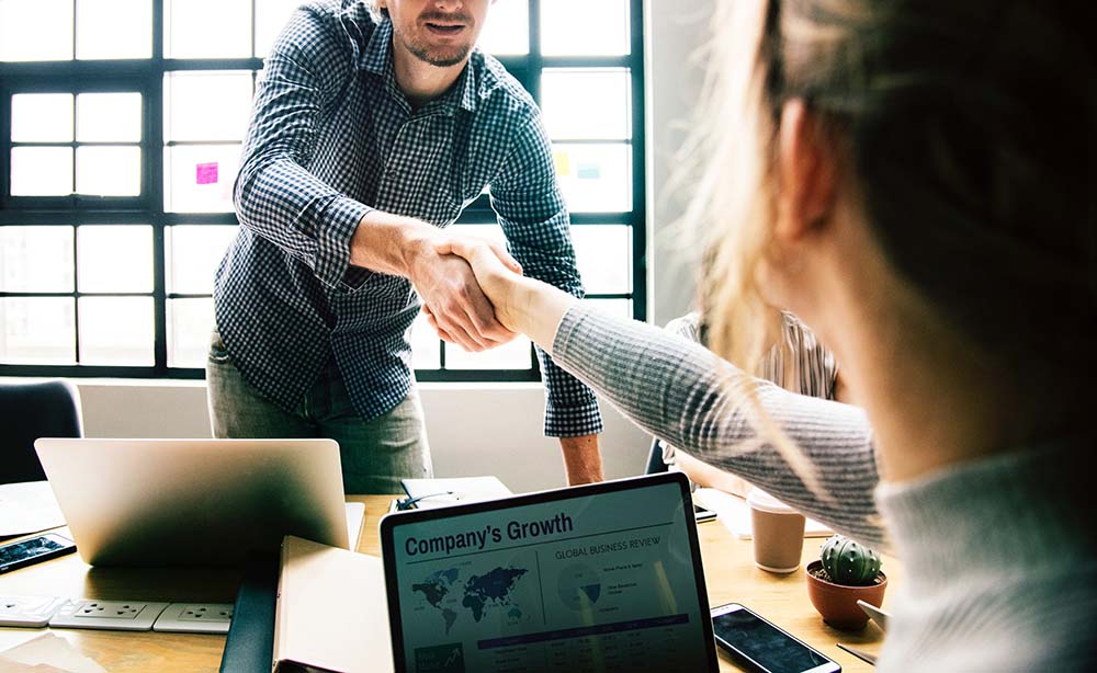 2 business people shaking hands - exporters