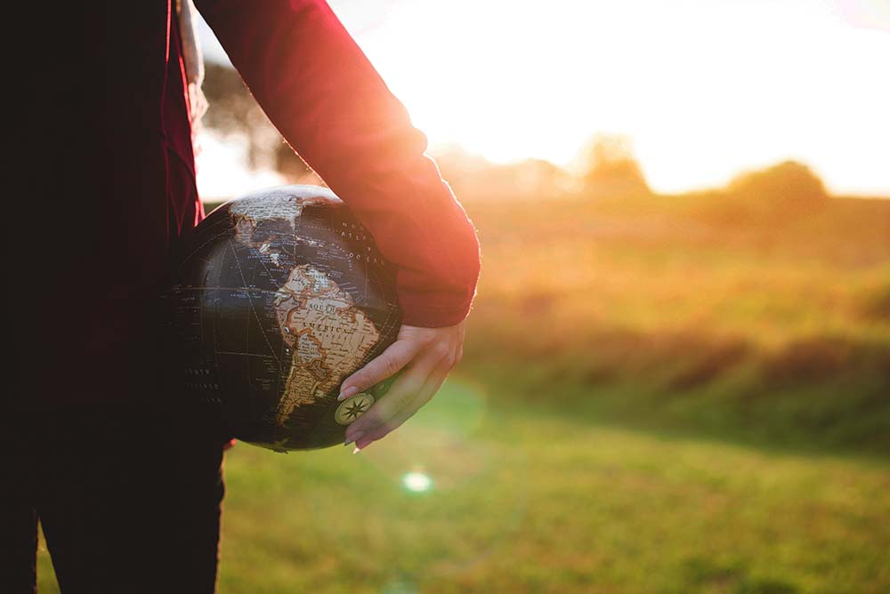 Person holding a globe