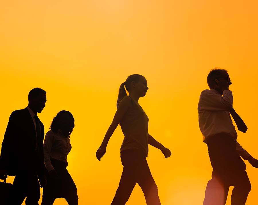silhouette of 4 people walking in a group