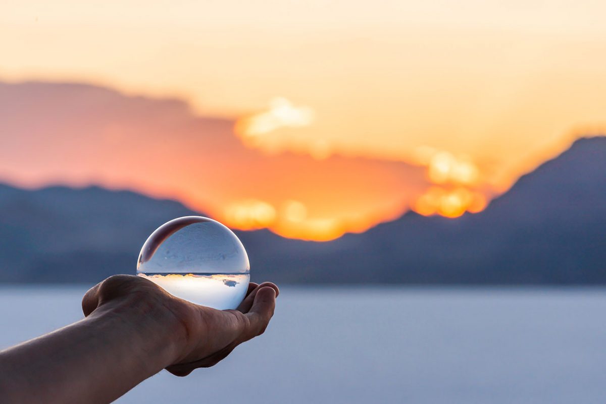 Crystal ball held in outstretched palm