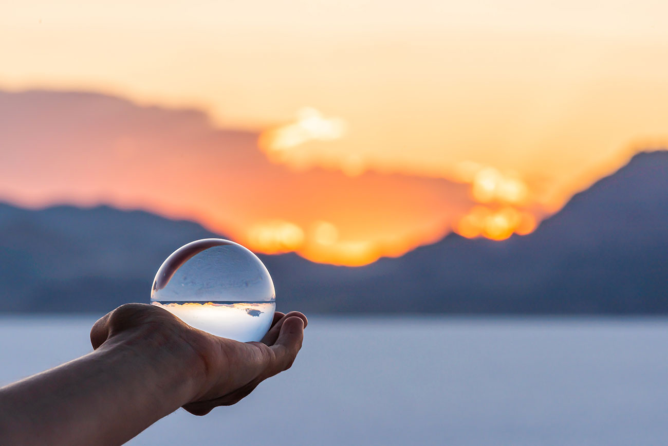 Crystal ball held in outstretched palm