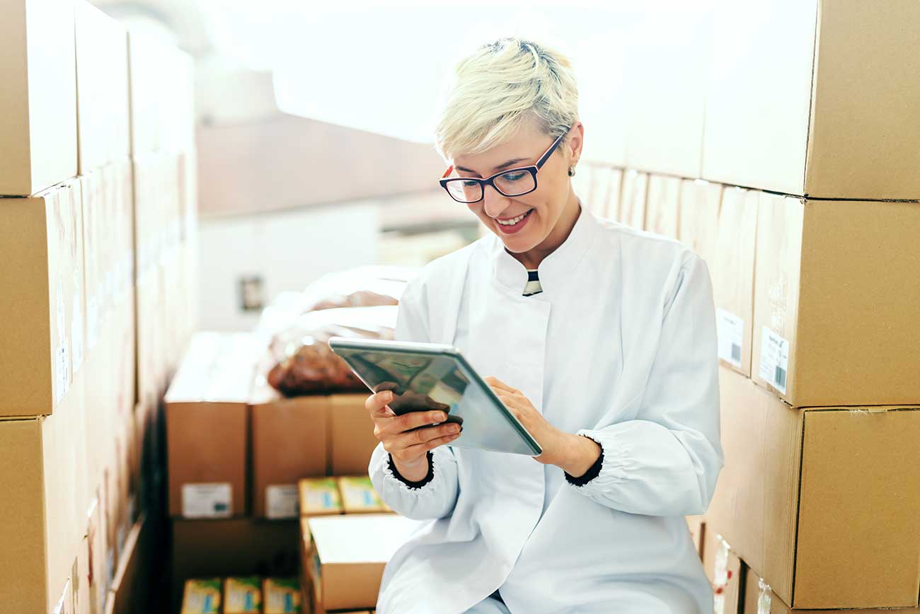 woman in warehouse with tablet