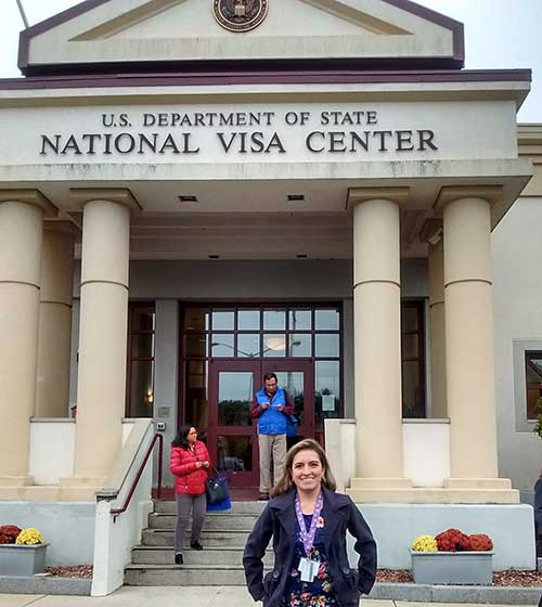 Esmerelda standing in front of the U.S. Department of State National Visa Center