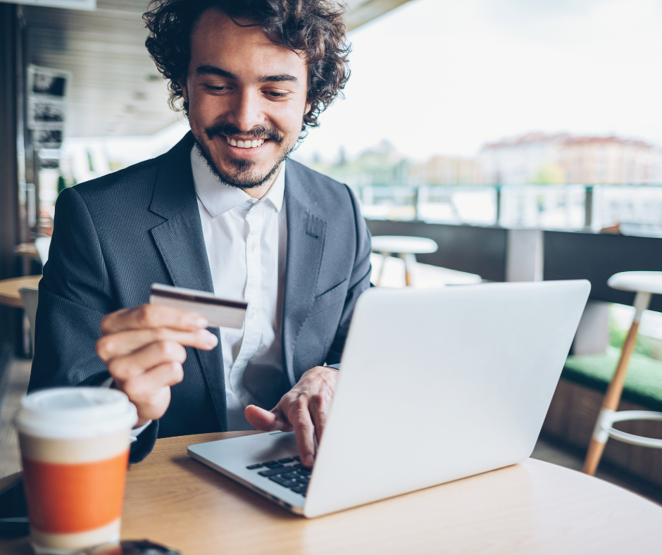 Man making a purchase using a credit card and laptop