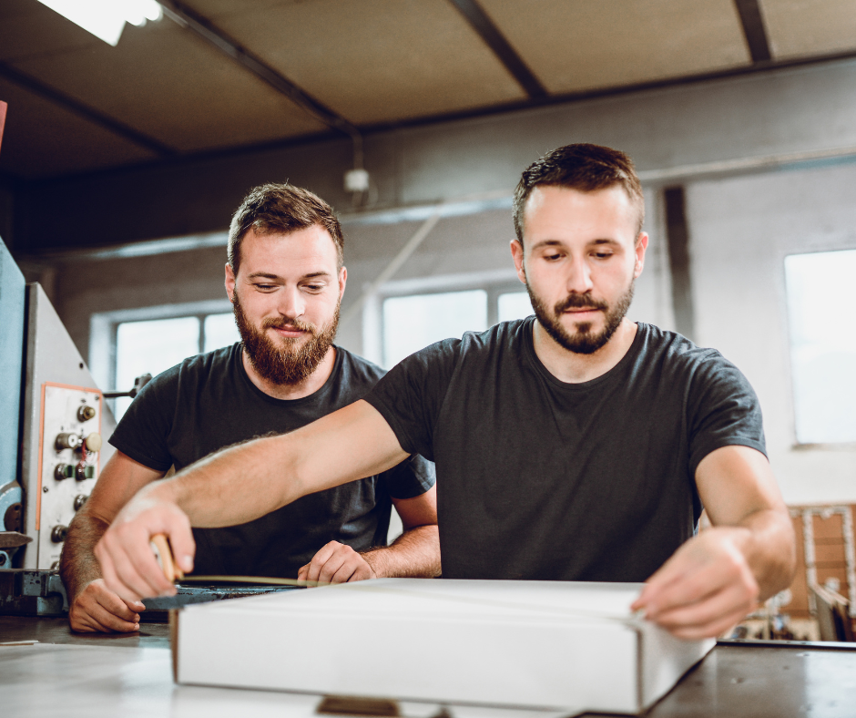 rating shipments - two workers measuring a box