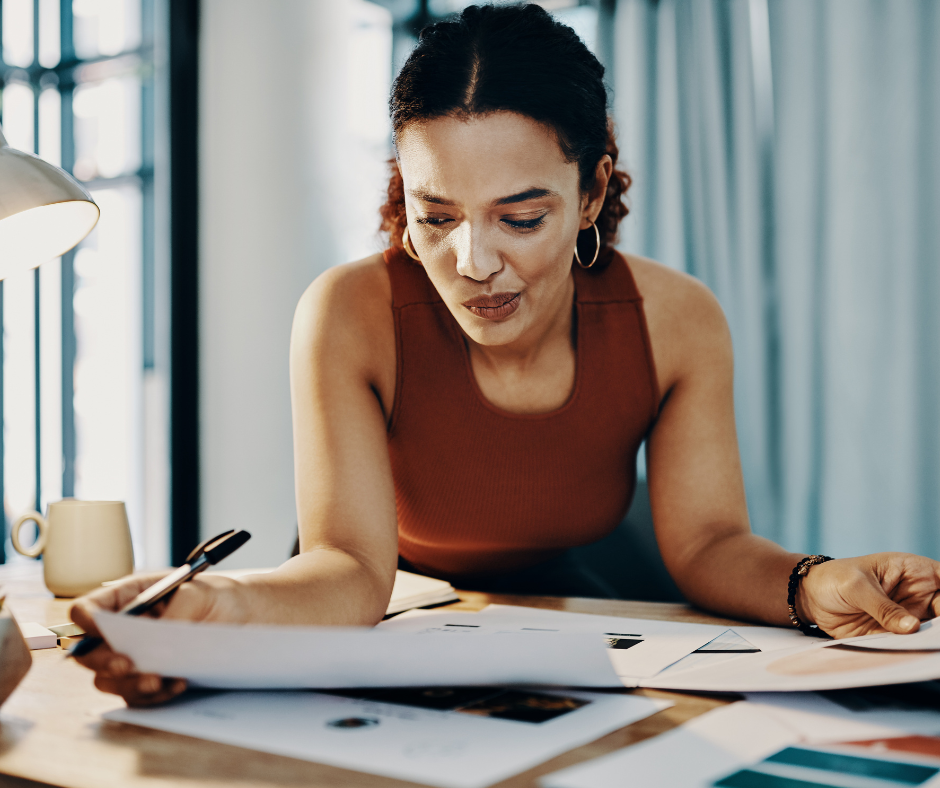 getting paid - methods of settlement in international trade - business woman examining documents at desk