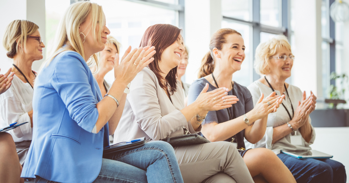 women applauding at event similar to WPO entrepreneurial excellence