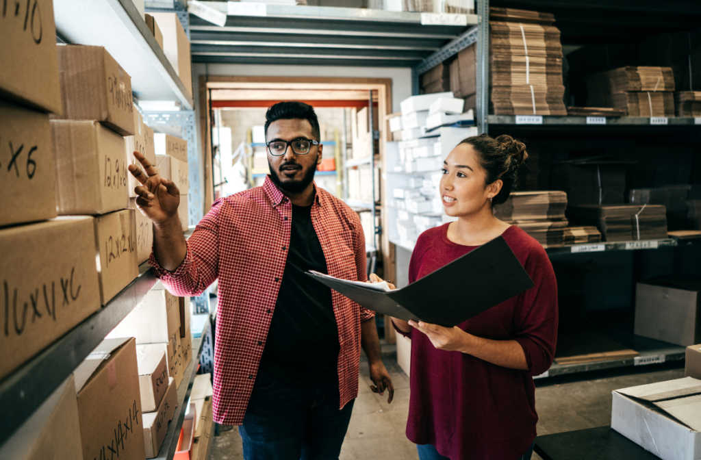 two people looking at boxes in a diverse supplier warehouse
